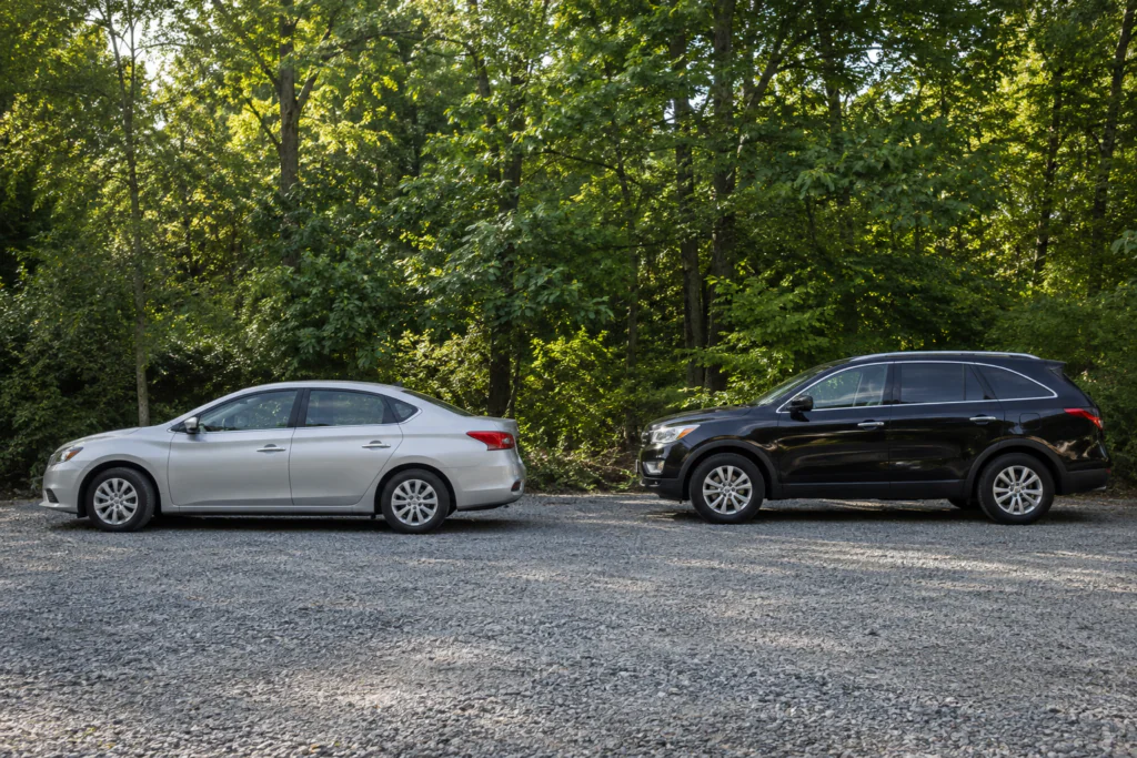 Passenger vehicles parked beside a suburban road